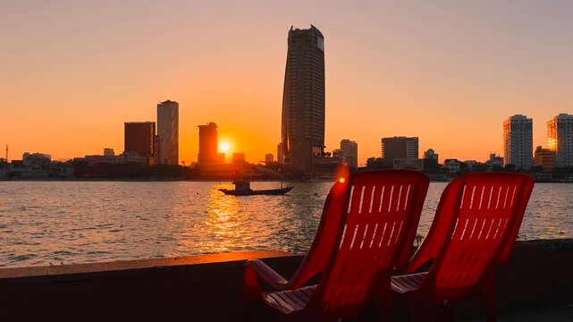 Two Red Riverside Plastic Chairs for watching Sunset over Han River and Cityscape