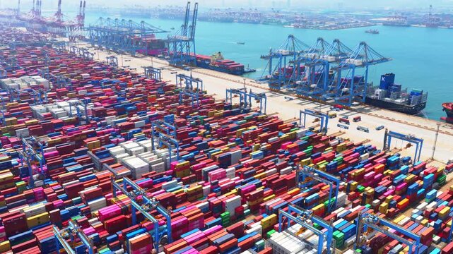 Aerial drone view of Qingdao fully automated smart container port, unmanned intelligent dock with automated cranes and container stacks for global shipping logistics。