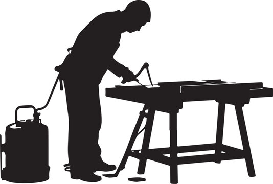 Silhouette of a man welding on a workbench with a gas worker