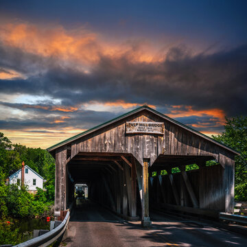Dramatic cloudscape over the historic landmark Pulp Mill Covered Bridge, Vermont&rsquo;s oldest surviving covered bridge built in 1808 and 1820, spanning the Otter Creek in Middlebury, Vermont, USA