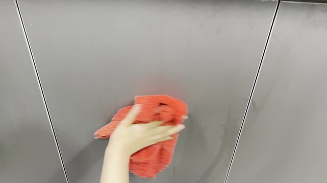 Cleaning Dark Gray Kitchen Cabinet Close-up, Hand Wiping Modern Matte Furniture Surface with Red Microfiber Cloth, 16:9 Landscape Housekeeping Footage