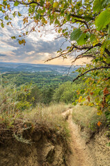 Fototapeta premium Curve road to the mountains. Scenic dirt road with mountain range.