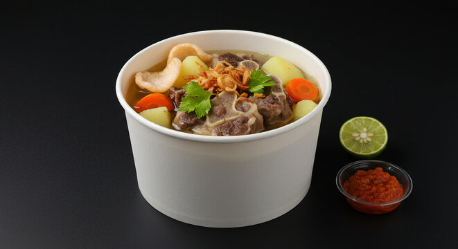 Indonesian Oxtail Soup Sop Buntut in Takeaway Bowl on Black