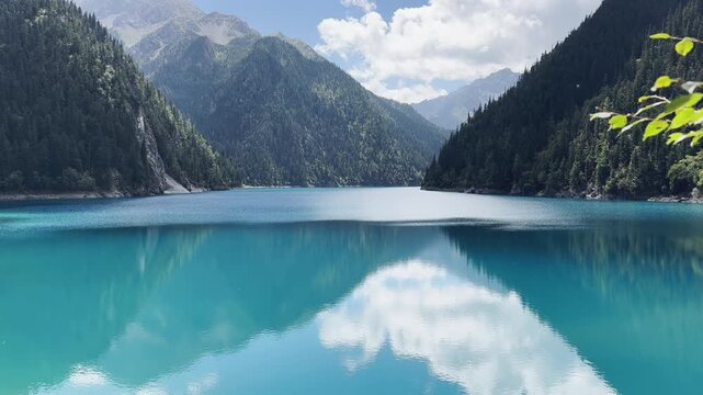 Breathtaking 4K Slow Motion Shot of Pristine Turquoise Lake and Mountain Reflection at Jiuzhaigou National Park Sichuan China, Serene Nature Landscape