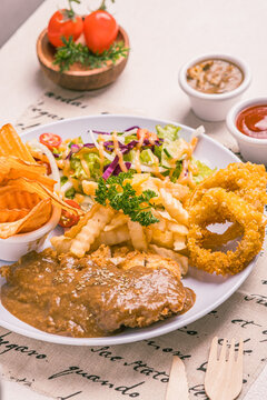 the ultimate combo featuring juicy katsu,golden french fries,crispy onion rings. and hey,we added a fresh salad on the side just to keep things balanced