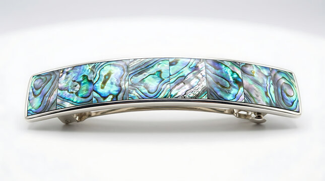  Luxury paua shell hair clip with an artisan-crafted mother of pearl pattern set in a minimalist silver frame isolated on a plain white background. 
