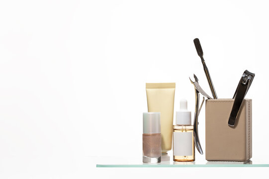 Professional manicure set featuring essential tools and premium skincare products, nail clippers, cuticle nippers, and soothing oils are arranged elegantly for a spa-like experience.