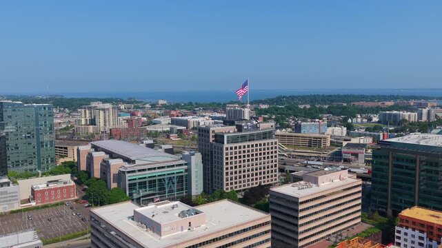 Stamford, CT skyline with big US Flag. Long Island Sound and I-95 highway in the background, 4K aerial.