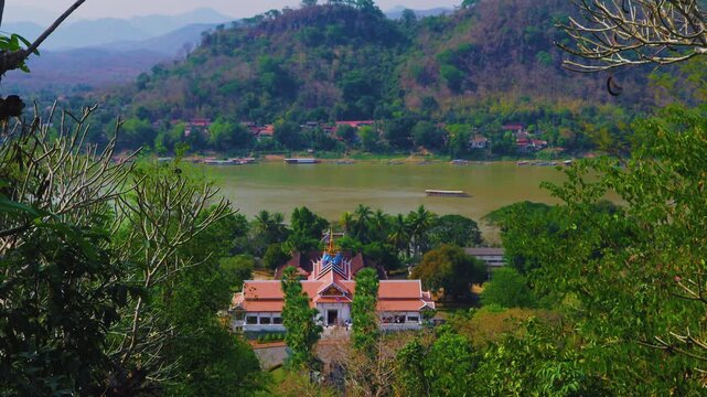 Panoramic view of the Royal Palace Museum and Mekong River surrounded by lush tropical mountains a beautiful sunny day Luang Prabang Laos