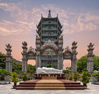 Reclining Buddha statue in front of the Xa Loi Tower at the Linh Ung Pagoda on Son Tra Peninsula, Da Nang, Vietnam at sunset