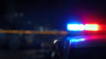 Fototapeta premium A close-up view of police lights illuminating a nighttime scene, symbolizing law enforcement and public safety.