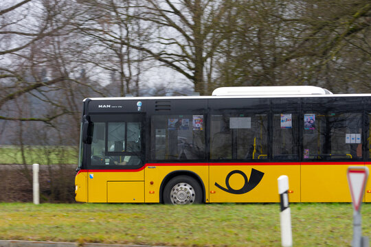 bus, car, europe, yellow, red, black, horn, swiss post bus, roundabout, traffic circle, passing, editorial, close-up, closeup, road, tree, brown, green, meadow, grass, gray, sky, transport, niederglat