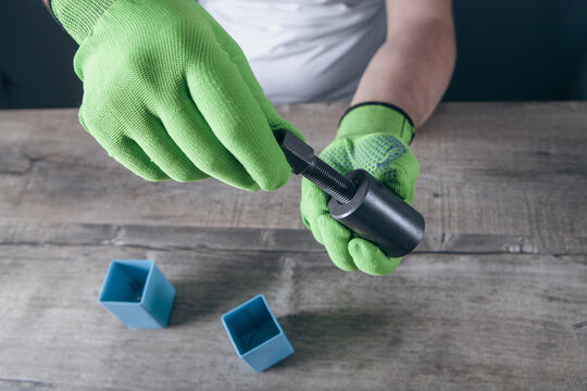 a man holds a puller in his hand