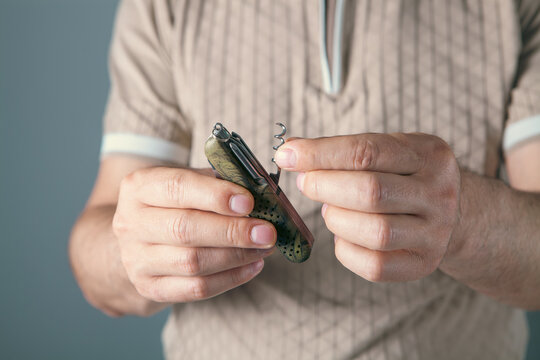 a man holds a multifunctional tool in his hand