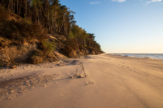 Golden sunset light on the beach in Dziwnowek, Poland