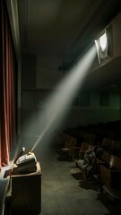 Naklejka premium Theater auditorium with spotlight beam shining through the smoke-filled air