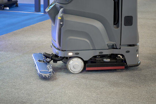 Automated appliance cleaning the carpet floor. Selective focus.