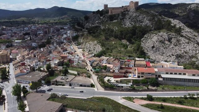 Aerial approach to the old town of Castalla, Spain, with the castle on top of the hill.