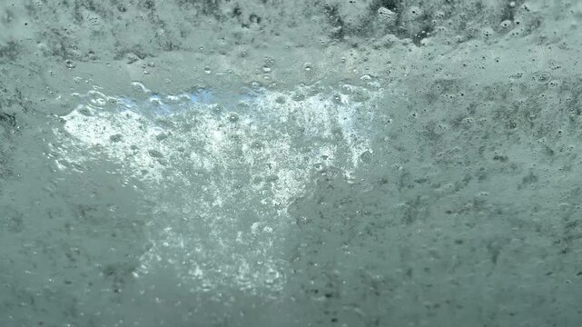 A drive through car was operating with it's jets of water and rotating brushes seen through the from window of a car, Worcestershire, England.
