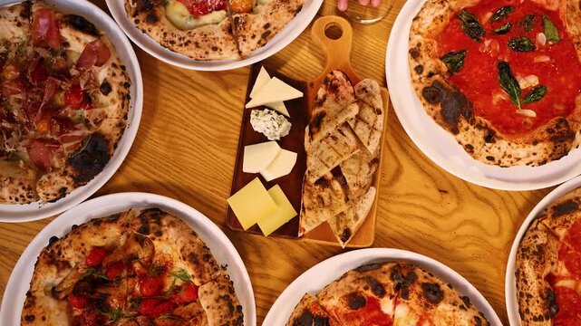 Overhead View of Italian Feast with Neapolitan Pizza and Antipasto Board