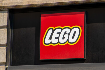 Obraz premium Lego Store Sign on the Wall of a Building with Famous Red and Yellow Brand Logo. Milan, Italy - June 24, 2026
