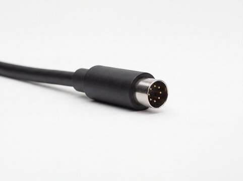 Close up of black fiber optic cable connector on white background