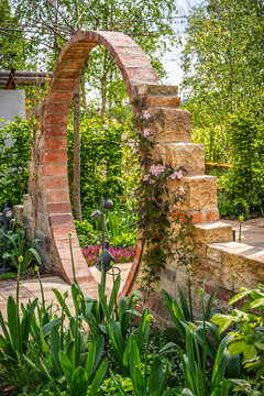 Charming garden archway with climbing flowers and lush greenery