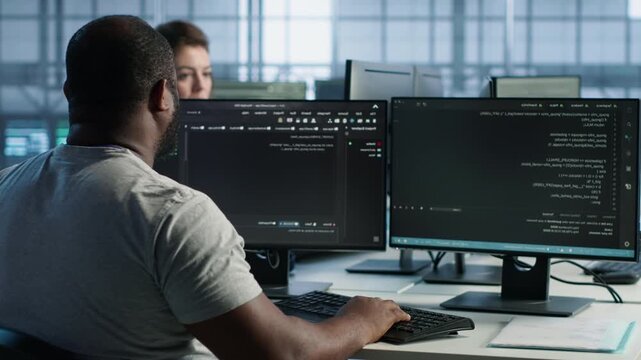 Data center developer typing code on PC to mend data center racks while highlighting data protection, network security and infrastructure risk.
