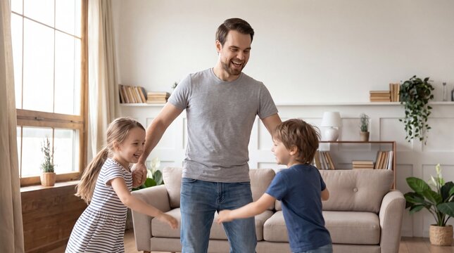 Joyful father playing with his happy children at home, a candid family moment of bonding and fun, active parenting lifestyle.