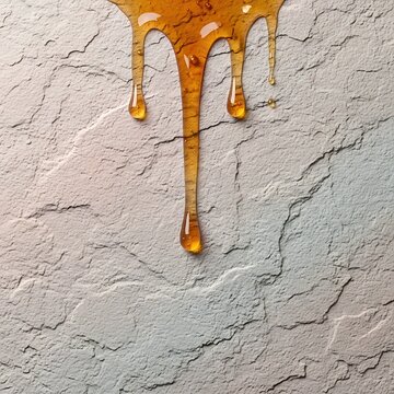Golden Honey Dripping Down Rough Gray Plaster Wall