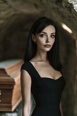 Fototapeta premium vampire woman with long raven hair in black dress, tall athletic female vampire portrait with hazel eyes, elegant gothic vampire with realistic skin and black dress