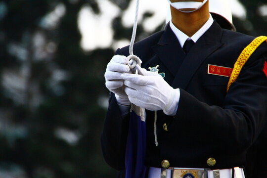 An honor guard handling flag rope during a ceremony.
