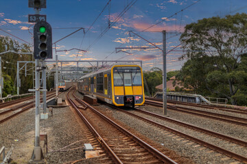 Obraz premium 7 July 2026 Passenger Train going through Lewisham Train Station at Sunset a suburban Sydney train Station in Sydney NSW Australia