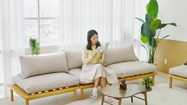 Young Asian Businesswoman Using Office Printer During Workday in Modern Workplace
