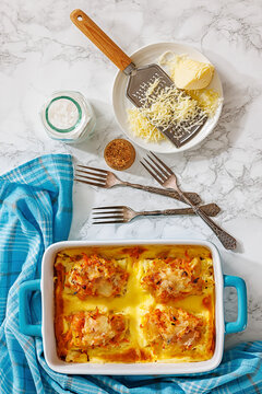 Cheesy Veggie Baked White Fish in blue baking dish