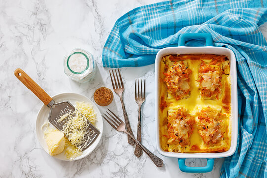 Cheesy Veggie Baked White Fish in blue baking dish