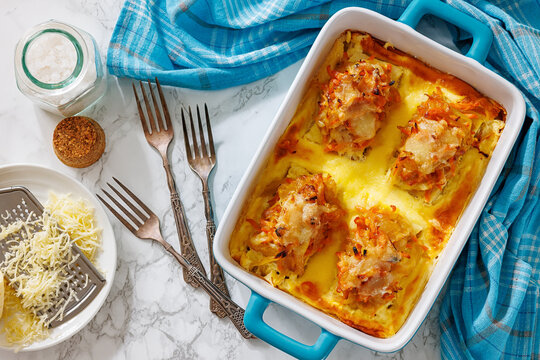 Cheesy Veggie Baked White Fish in blue baking dish