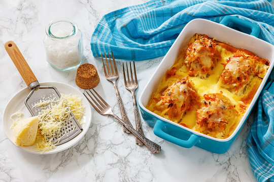Cheesy Veggie Baked White Fish in blue baking dish