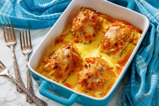 Cheesy Veggie Baked White Fish in blue baking dish