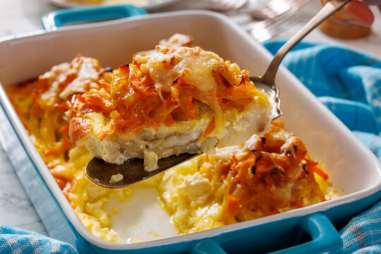 Cheesy Veggie Baked White Fish in blue baking dish