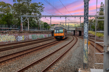 7 July 2026 Passenger Train going through Lewisham Train Station at Sunset a suburban Sydney train Station in Sydney NSW Australia © Elias Bitar