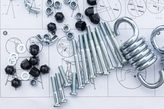 flat pack for garden furniture assembly, screw-nuts, screws, and parts on a paper furniture assembly instruction sheet
abstract technology background with various details