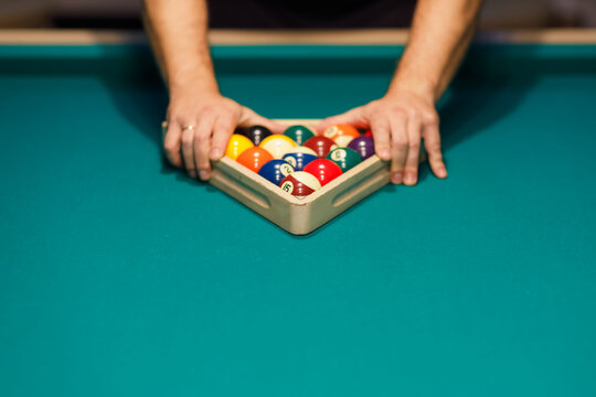 Billiard player preparing billiard table for snooker billiards pool game