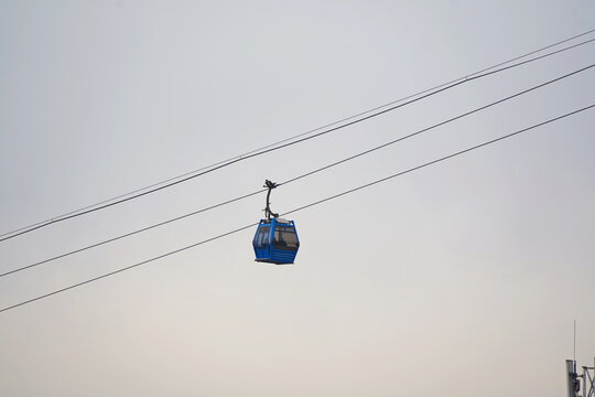 The cable car. The booths are moving over the city. Urban tourism in Almaty.