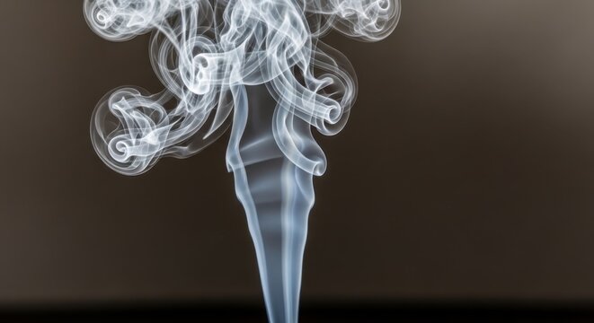 Smoke swirls rise up in air forming patterns indoors
