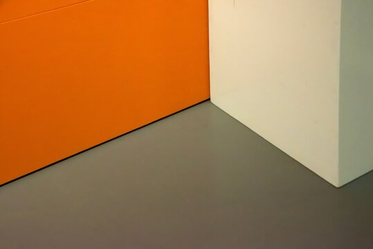 Corner of a room with orange and white walls