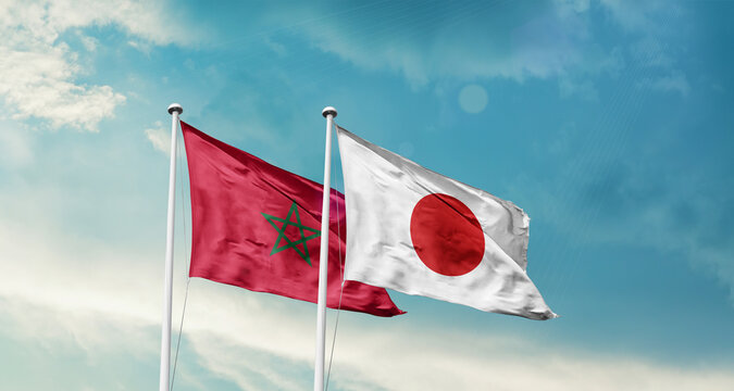 Morocco and Japan friendship flags are waving in the sky. Two country flag for agreement or deal. Morocco Japan national flag for commitment.