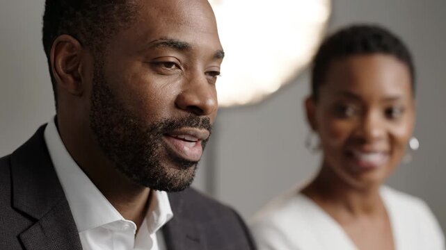 African American business professionals engaged in focused discussion during corporate meeting