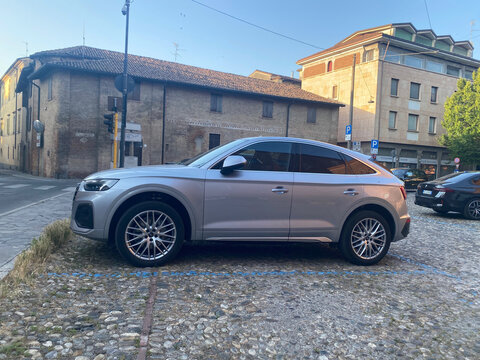 Audi Q5 Sportback, a premium compact SUV coupe, parked on cobblestones in Cremona, Lombardy, Italy urban street
