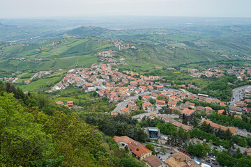 Fototapeta premium Panoramic view from the fortress of San Marino over surrounding landscape under dramatic cloudy sky